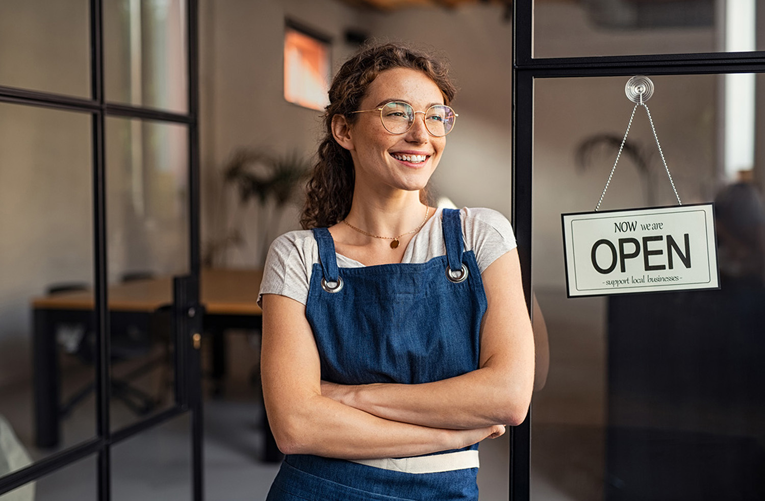 shop owner with open sign